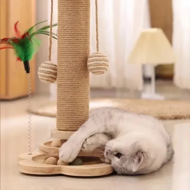 Cat playing with a wooden scratching post and feather toy on a light-colored floor.