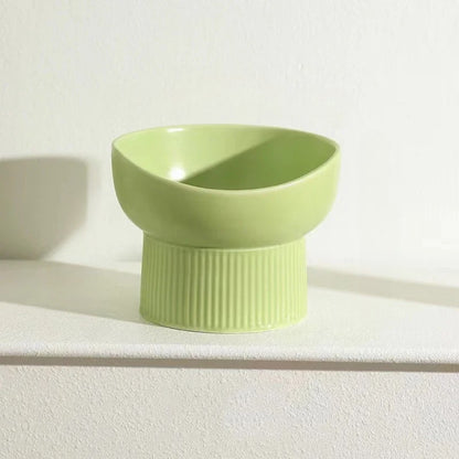 Green ceramic bowl on a white surface with a light background